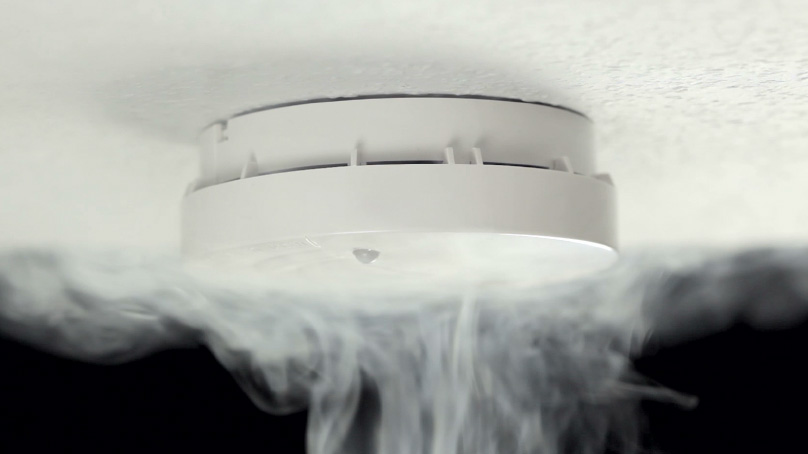 Home smoke alarm with smoke billowing