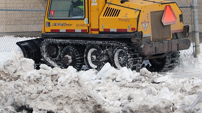 snow clearing machine on sidewalk