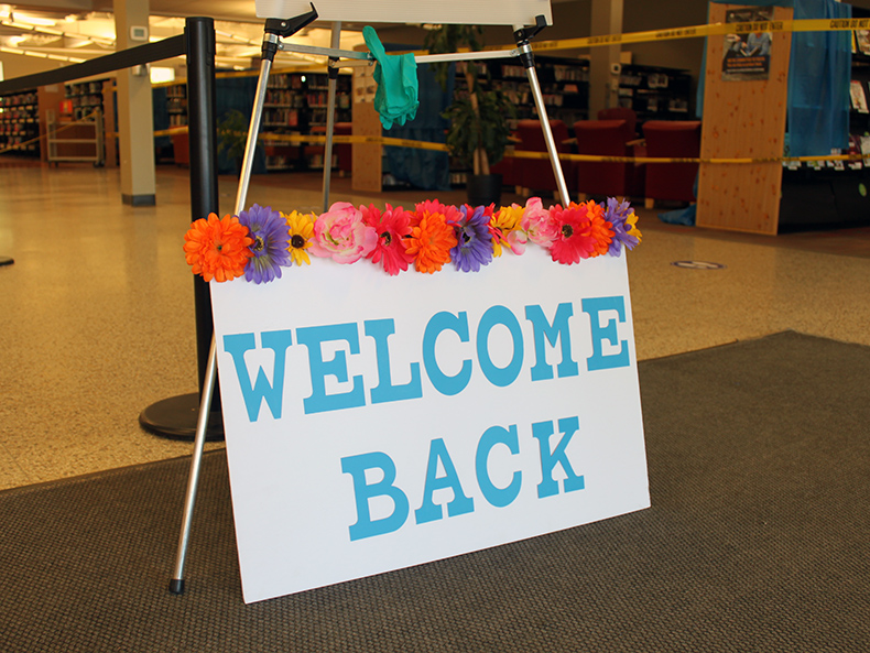 Welcome back sign at entrance to the library to mark service resumption