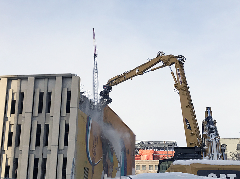 Overview of demolition of public safety building by cranes