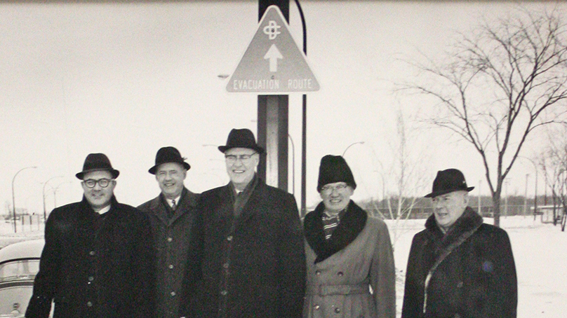Installation of evacuation route signs in Metropolitan Winnipeg with A. Bentley, Provincial Coordinator of Emergency Measures Organization and Metro officials Bernie Wolfe, R.H.G. Bonnycastle, Andrew Currie, and James S. Mulholland, February 1966. 