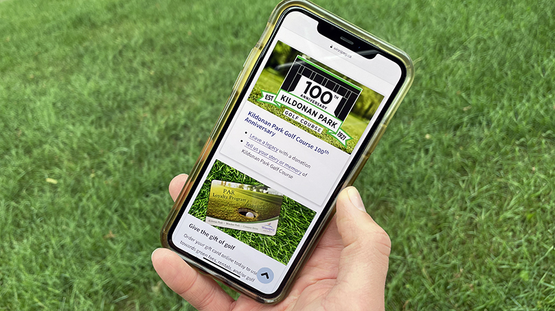 Person holding a phone using golf mobile friendly app
