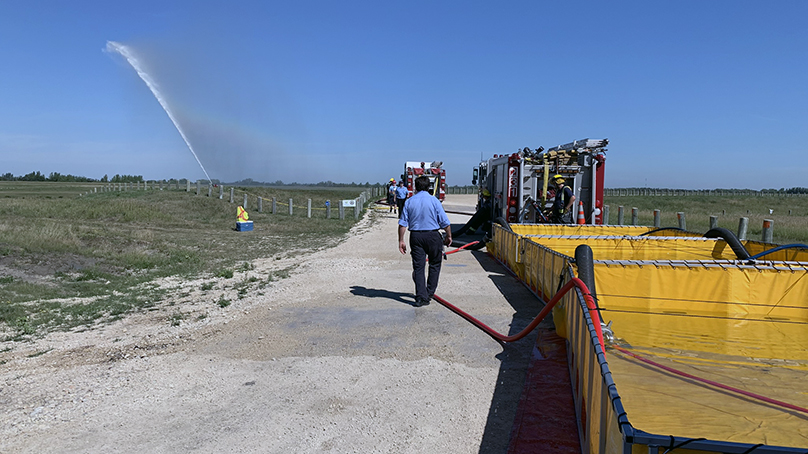 Winnipeg Fire Paramedic Service (WFPS) spraying water with Superior Tanker Shuttle Service