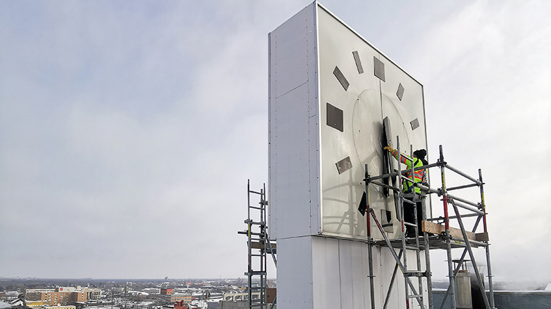 City crews repair the City Hall clock in 2020.