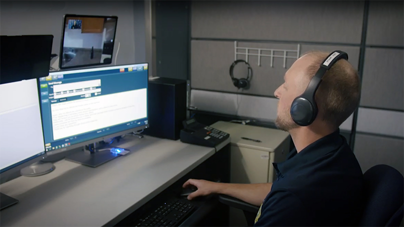 Virtual Police Response Winnipeg employee sitting at desk working on computer