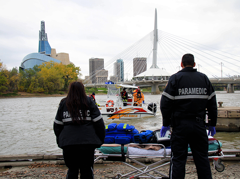 Water rescue equipment with paramedics on river bank