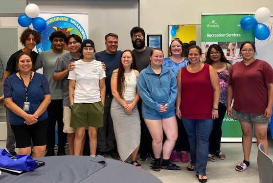 Staff celebrate with participants of the Youth Lifeguard Recruitment Program.