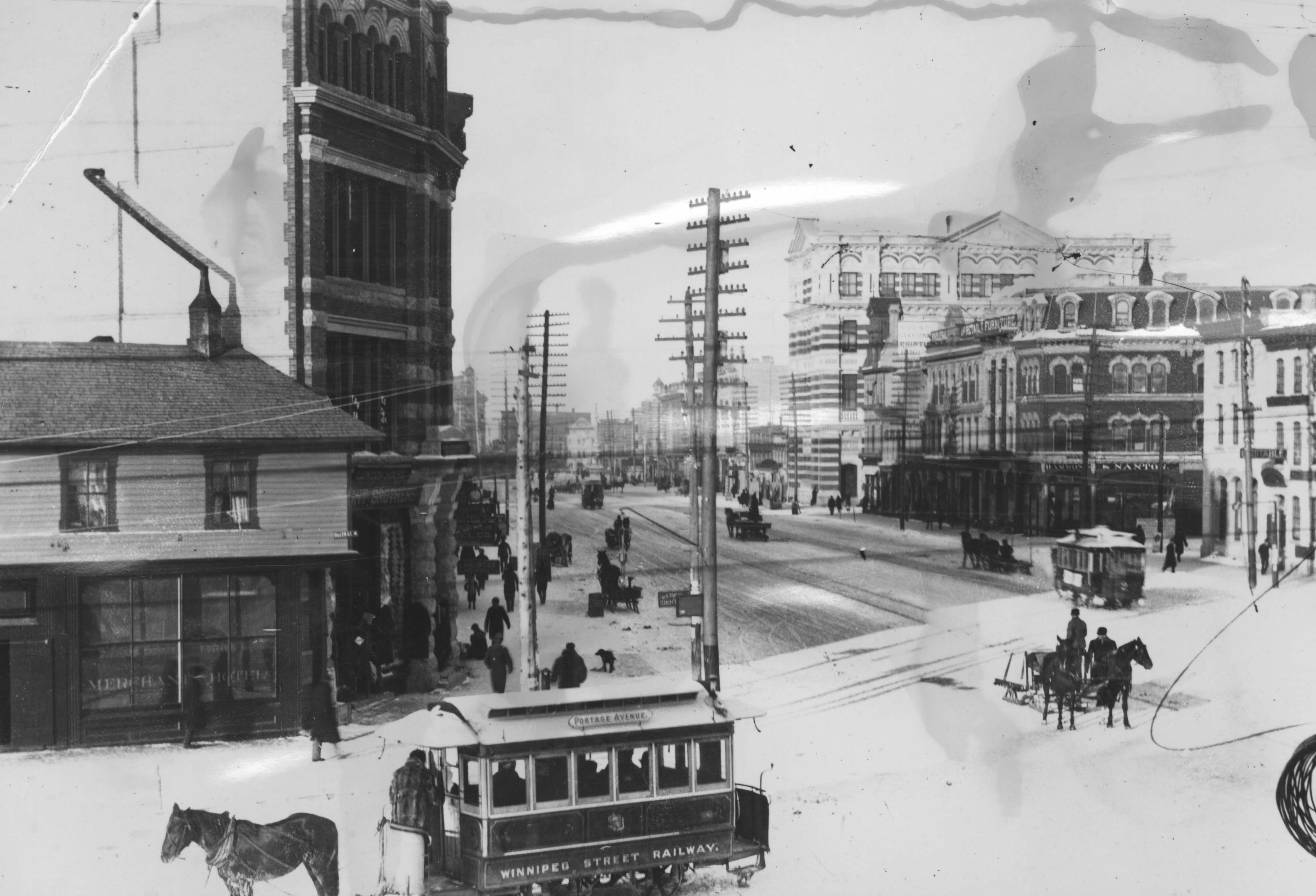 Street cars are seen on a street in an archival photo.