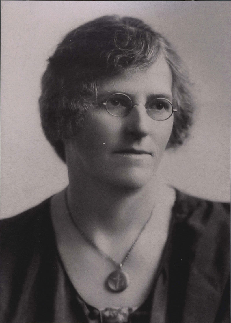 A woman wearing glasses is seen in an archival image.
