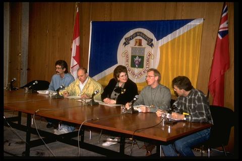 Then mayor Susan A. Thompson sits at a table (middle) for a press conference in a 1997 file photo.