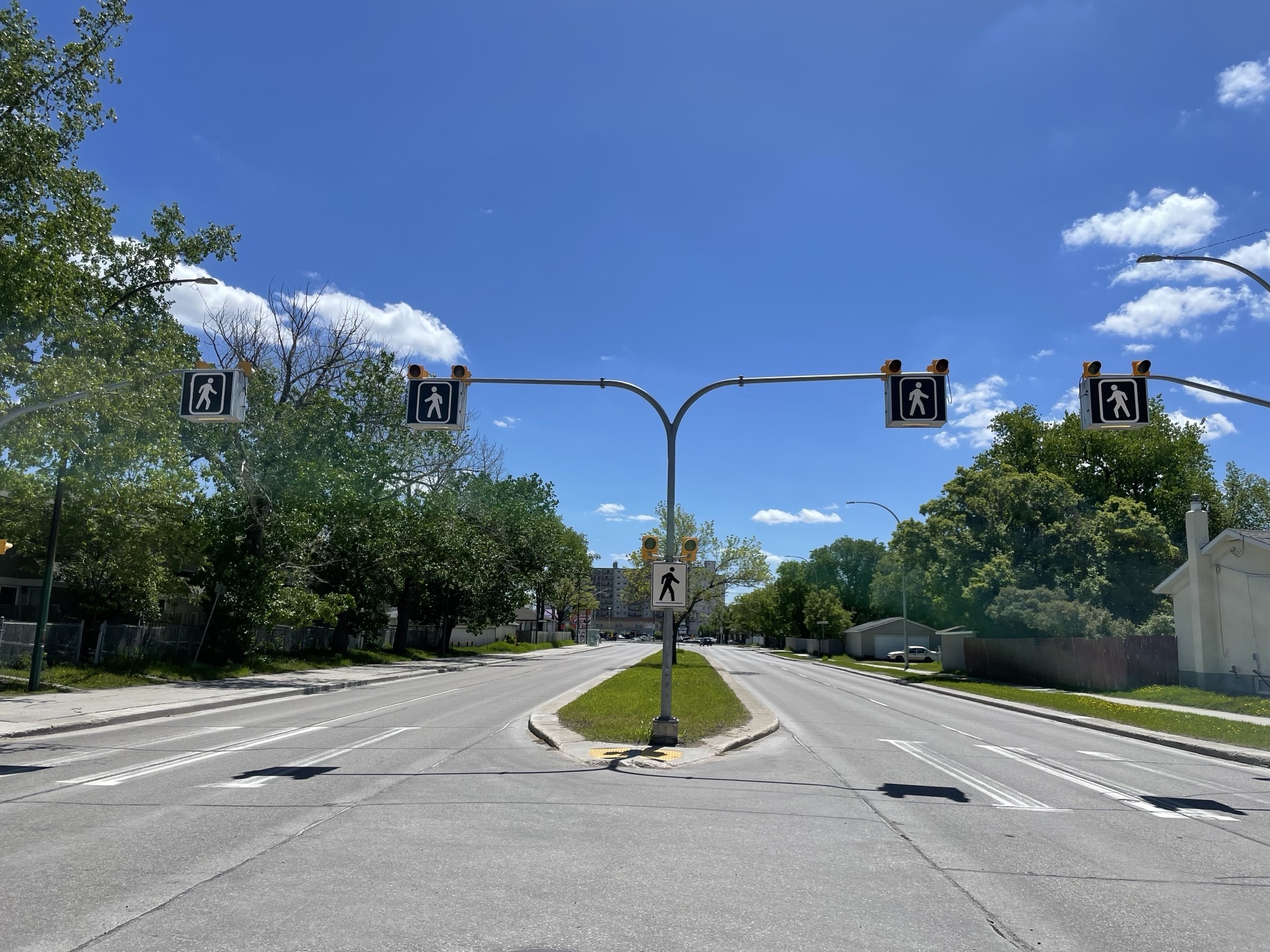 A narrow median stands in the middle of a street.