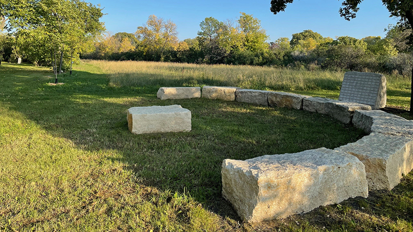 Large stones in a semicircle in a grassy area.