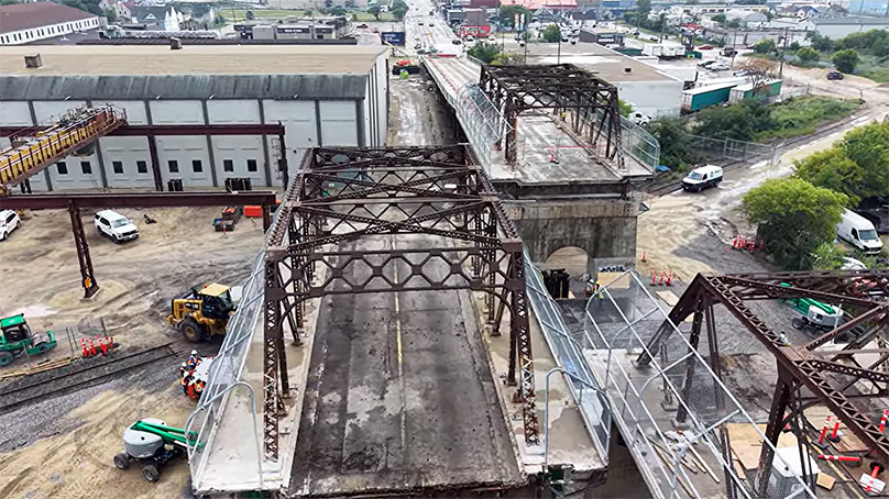 Aerial video of a piece of the Arlington Bridge deck moved to the side and removed