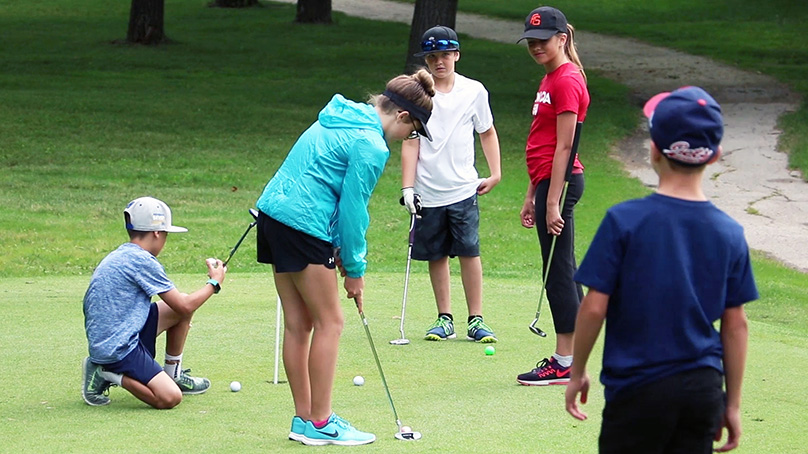 Children golfing on a putting green