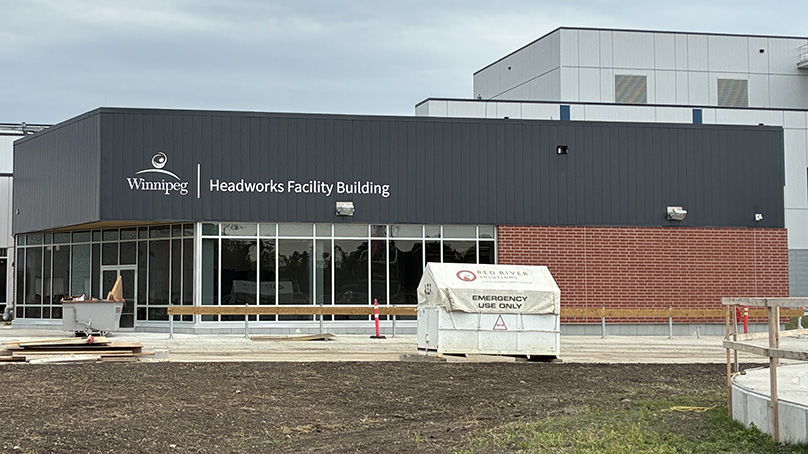 Exterior of an under constriction building with "Headworks Facility" on it.