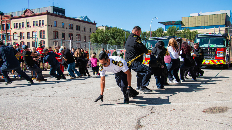 Teams of employees pulling fire engines