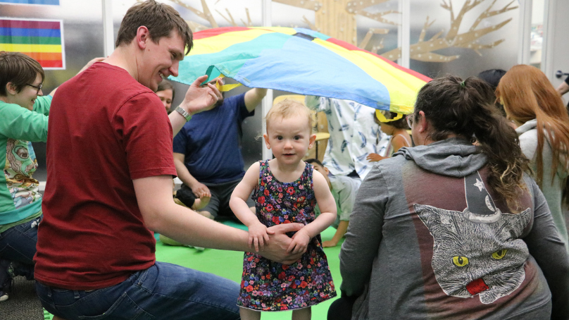 Child participating in a group program at a library