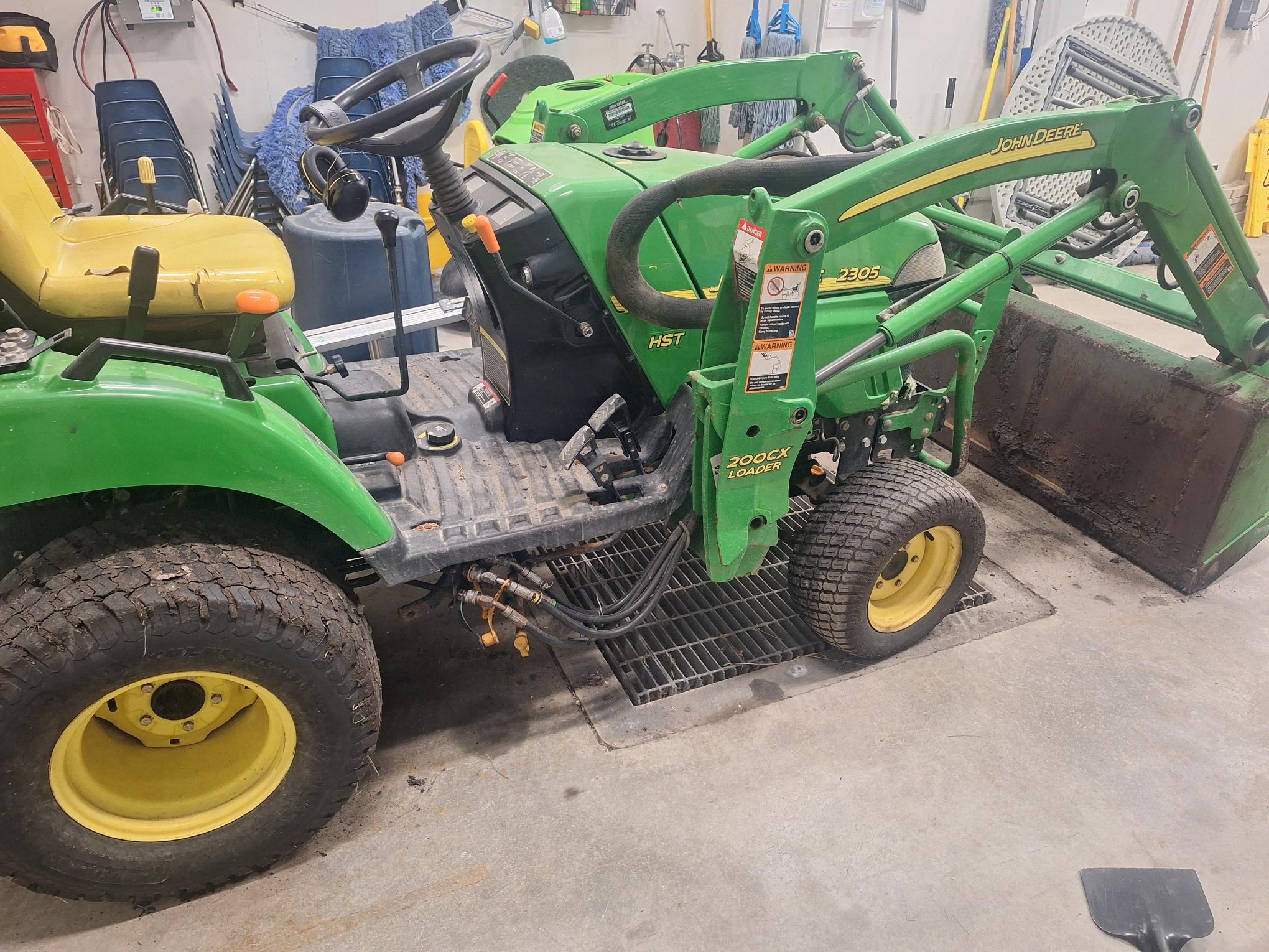Small green tractor with a front-end loader