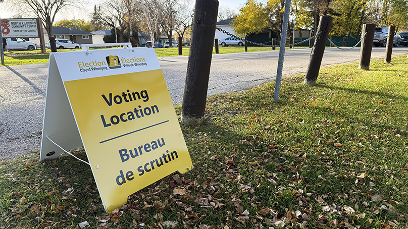 Voting location sign outside on a fall day