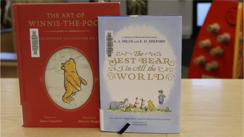 Two Winnie-the-Pooh books on display in a library
