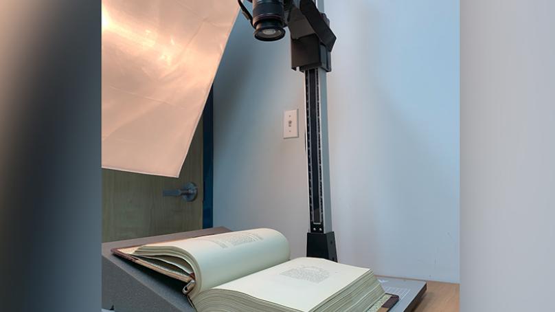 Camera above a book which is laying open on a table