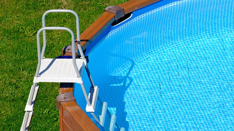 Ladder leading into backyard pool