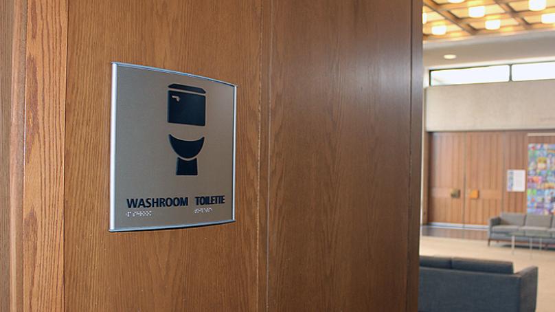 Sign on a bathroom door