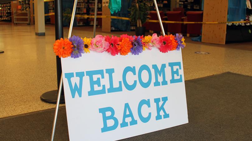 Welcome back sign at entrance to the library to mark service resumption