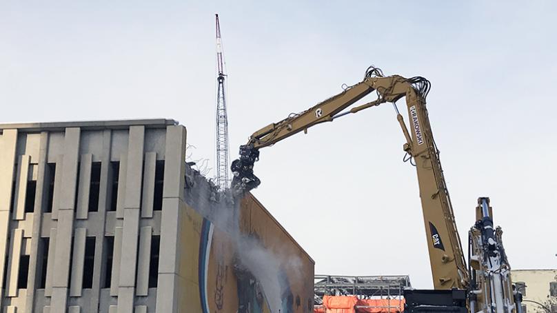 Overview of demolition of public safety building by cranes