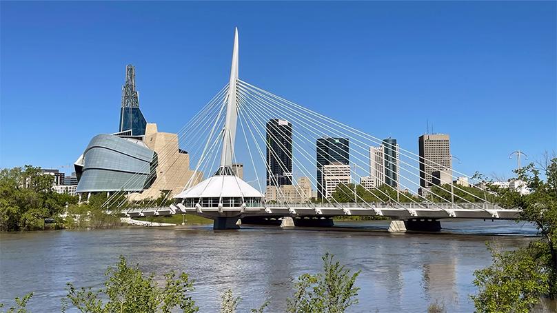 Downtown Winnipeg skyline as seen from across the Red River during the daytime. Features the Canadian Museum for Human Rights and the Esplanade Riel bridge.