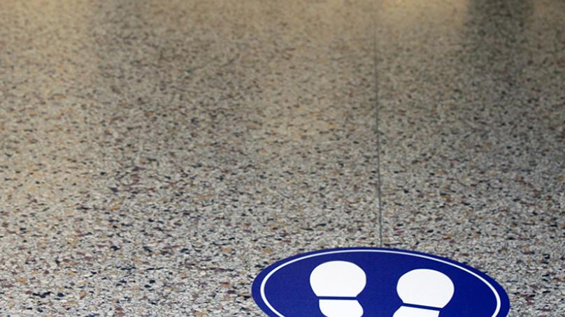 Two circular blue floor decals with white footprints