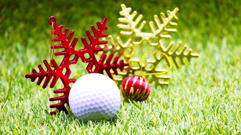 golf ball on grass with Christmas ornaments