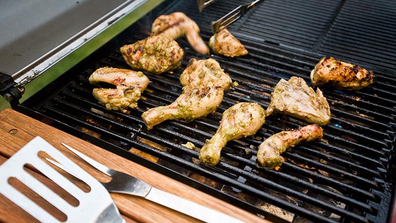 chicken pieces on a barbeque.
