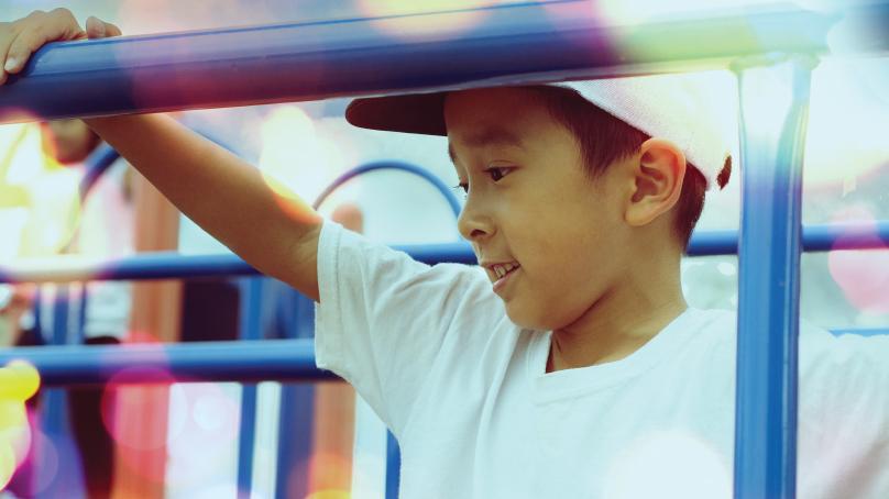 Boy having fun playing on play structure