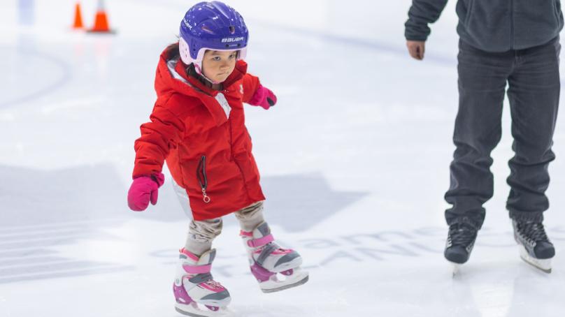 Child skating with parent