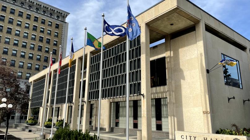 Flags fly around Winnipeg City Hall Council Building.