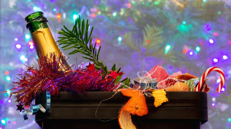 A garbage can full of holiday-themed garbage.