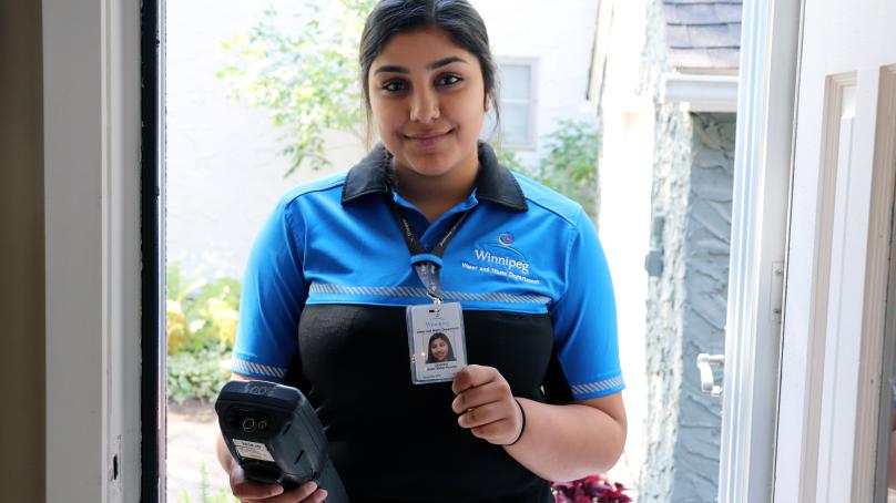 A meter reader shows their ID tag.