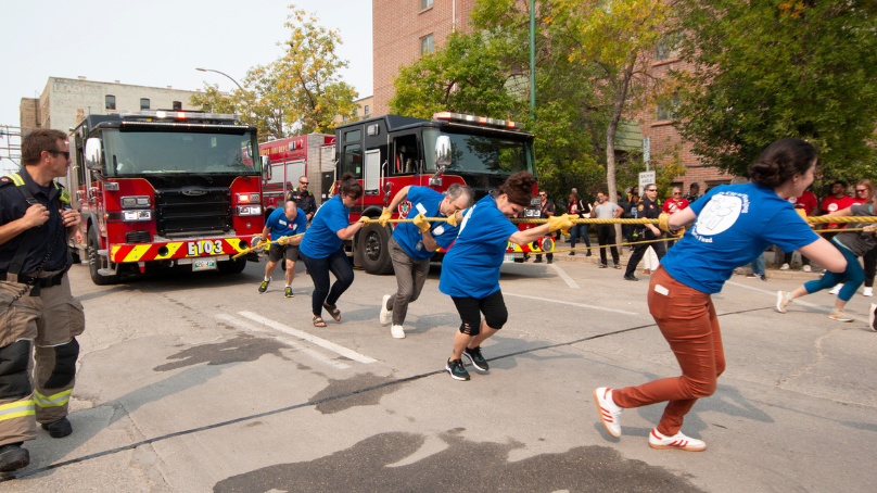 Employees pulling a fire engine