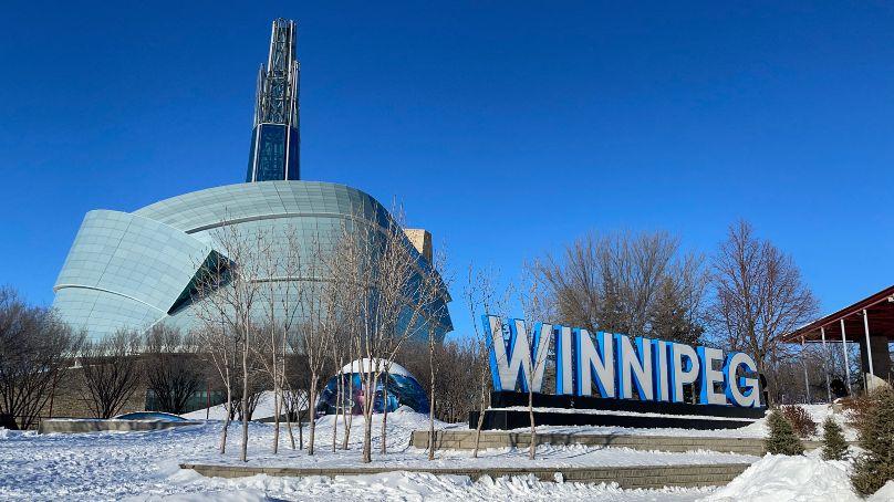Winnipeg sign with the Canadian Museum for Human Rights in the background