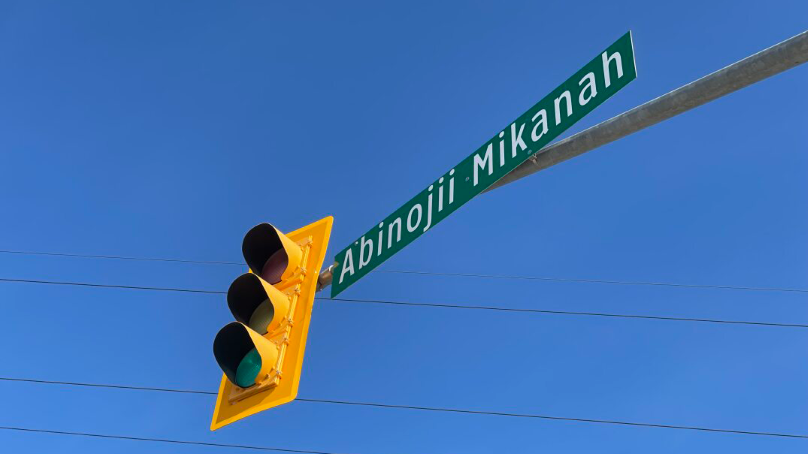 An overhead sign says "Abinojii Mikanah"
