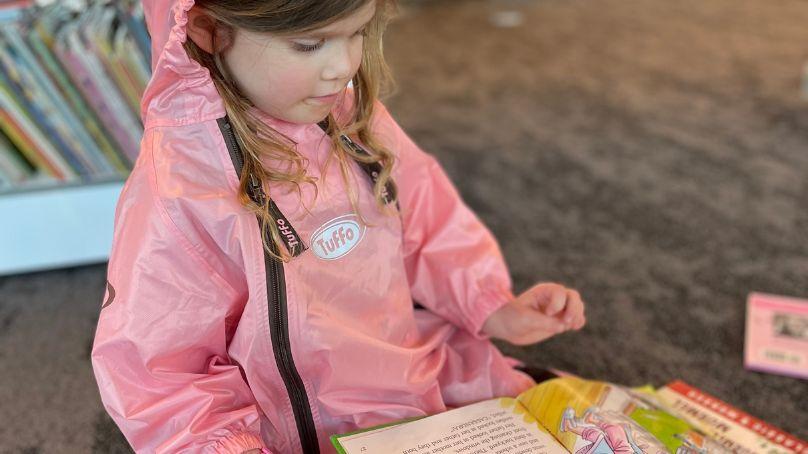 Child reading at a library