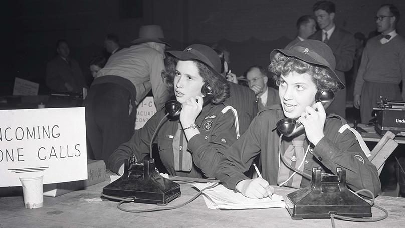 Girl Guides taking calls at Red Cross Flood Relief Headquarters in the Civic Auditorium during the 1950 flood.