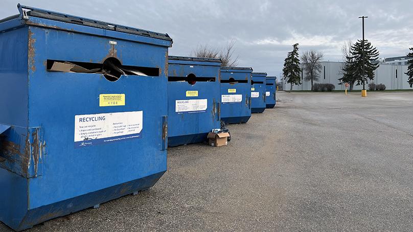 row of large blue recycling bins 