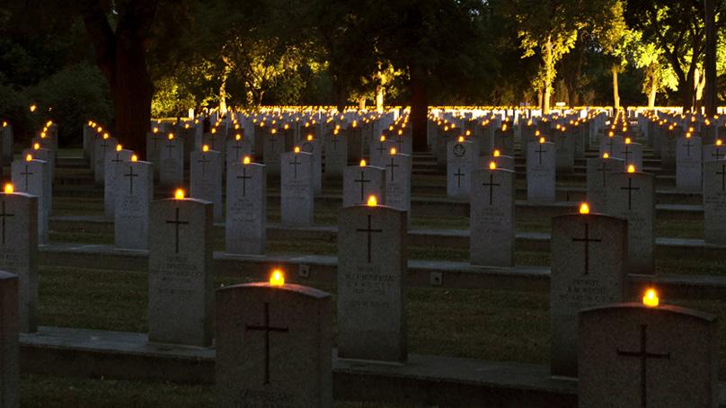 Flameless candles light graves in the Field of Honour at Brookside Cemetery