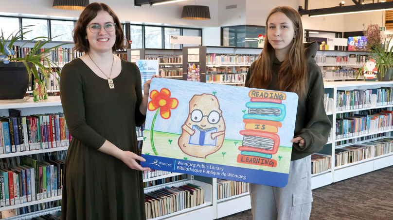 Kingsley, Teen Library Card Winner with staff member Hannah
