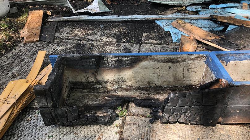 A charred flower planter that had caught fire.