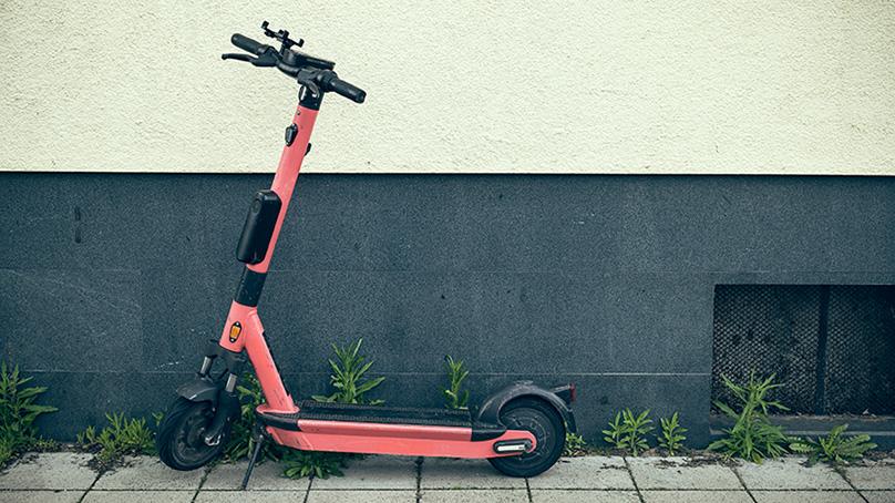 E-scooter leaning against the outside of a building