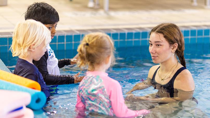 Three children and swim instructor in pool