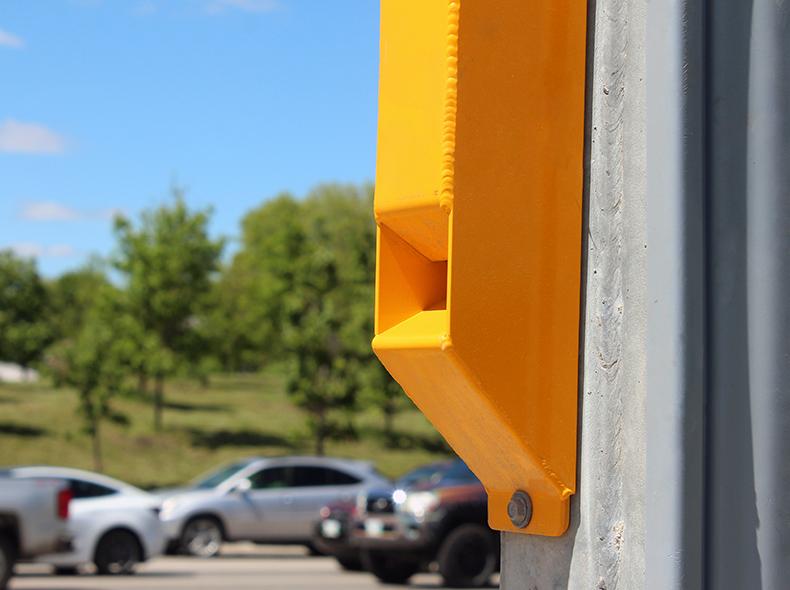 A yellow accessible pedestrian sound device.